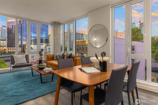 a living room with fireplace furniture and a large window