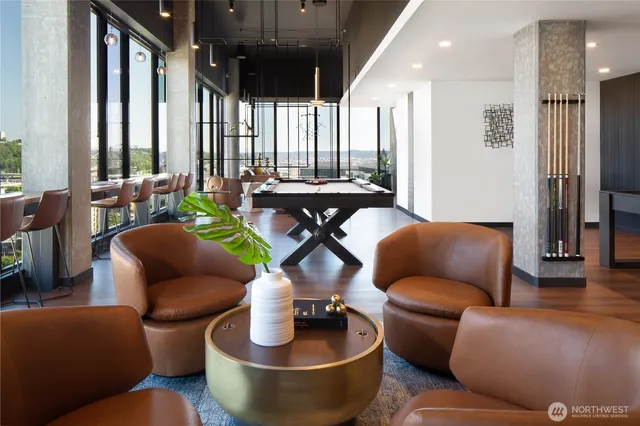 a living room with furniture and a floor to ceiling window
