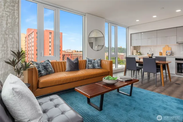 a living room with furniture a table and a large window