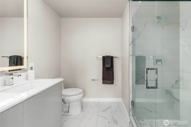 a bathroom with a toilet sink and shower