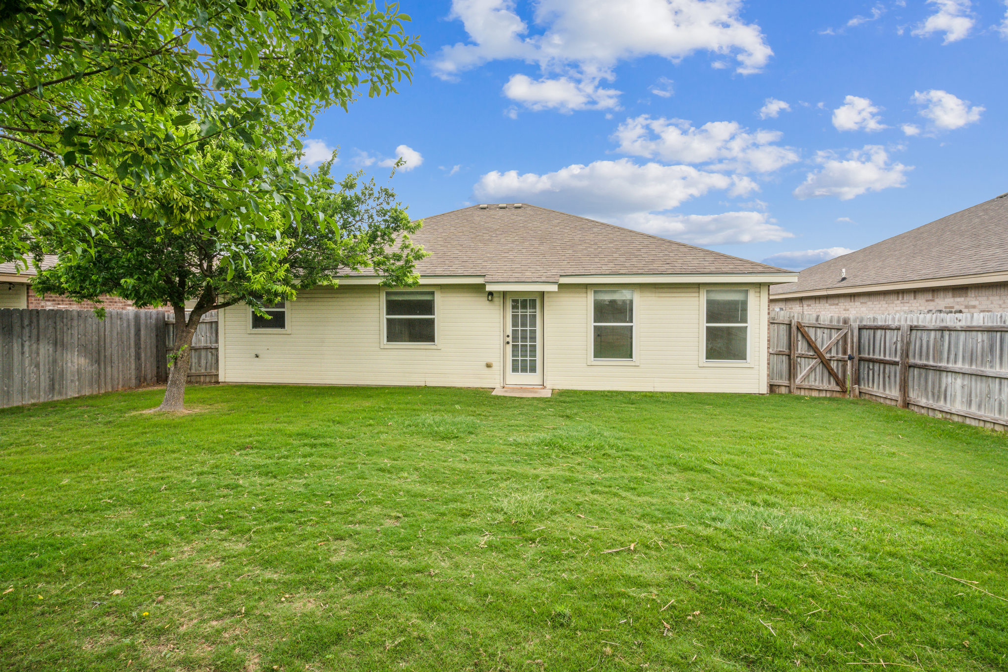 224 Amber Lane Jarrell, TX 76537 - Photo 16 of 16 Rear view of house featuring a fenced backyard and a shingled roof