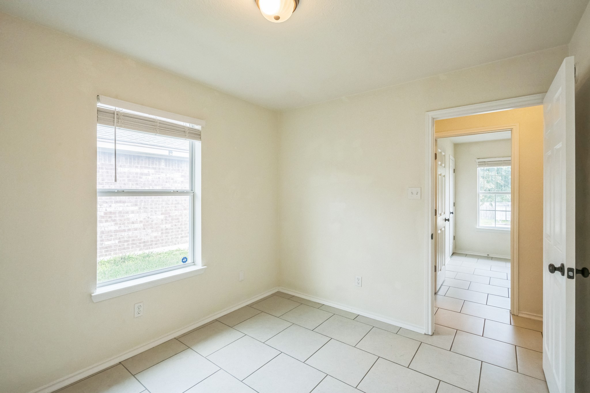224 Amber Lane Jarrell, TX 76537 - Photo 4 of 16 Unfurnished room with baseboards and light tile patterned floors