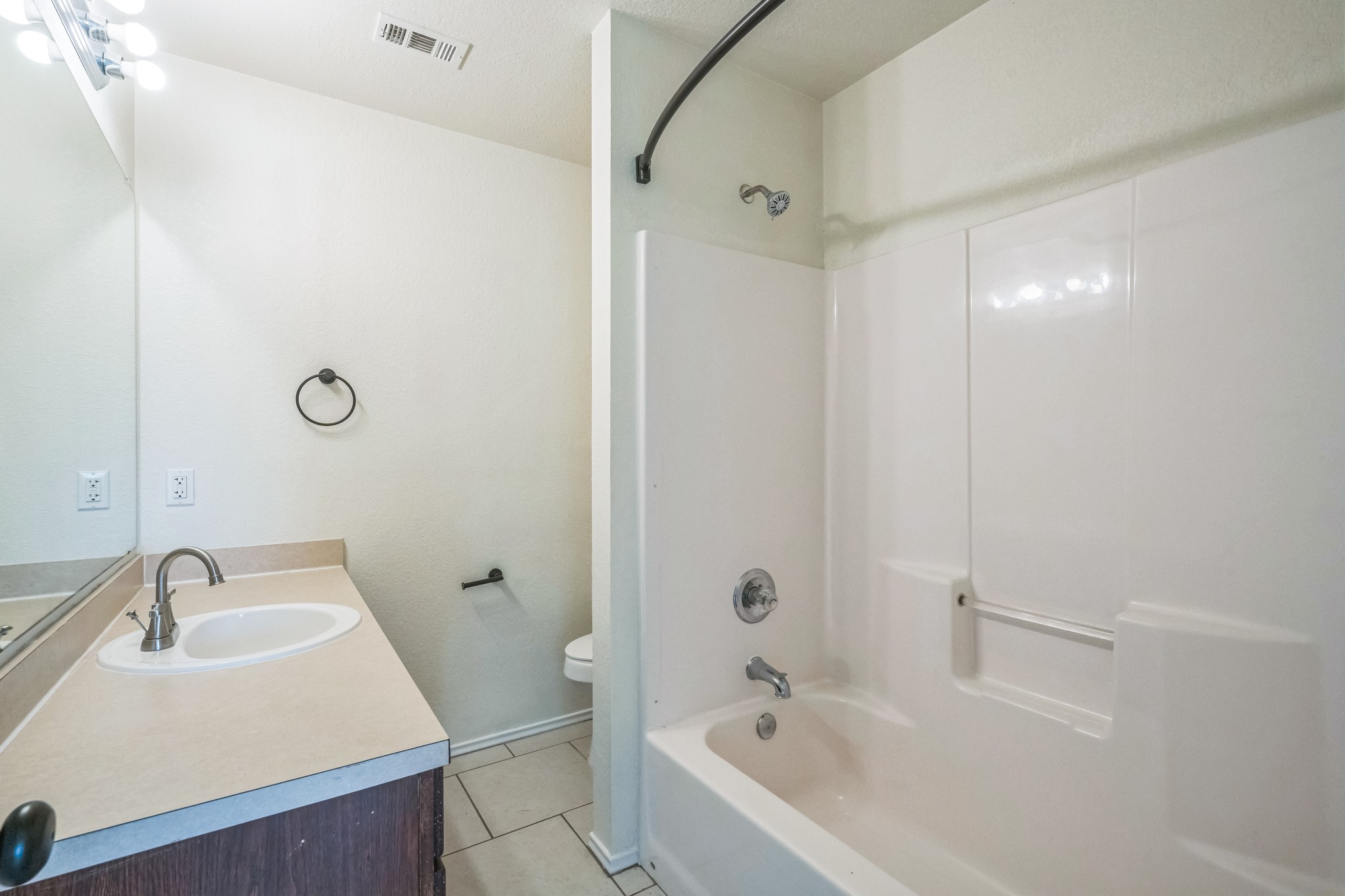 224 Amber Lane Jarrell, TX 76537 - Photo 7 of 16 Full bathroom featuring vanity, light tile patterned flooring, and shower / bathtub combination