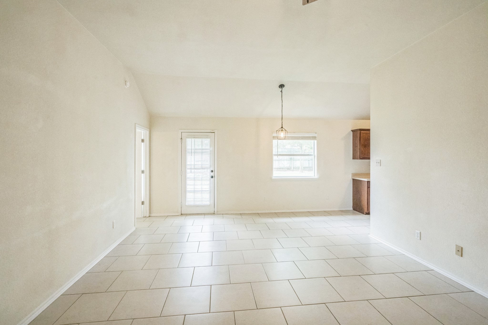 224 Amber Lane Jarrell, TX 76537 - Photo 10 of 16 Spare room featuring vaulted ceiling and light tile patterned floors