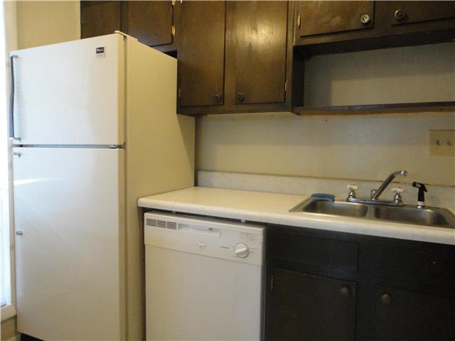 320 Welch Road, Unit M1 Nashville, TN 37211 - Photo 5 of 14 The kitchen features a refrigerator, stove, dishwasher, dark wood cabinets; double sink and plenty of storage for all your needs.