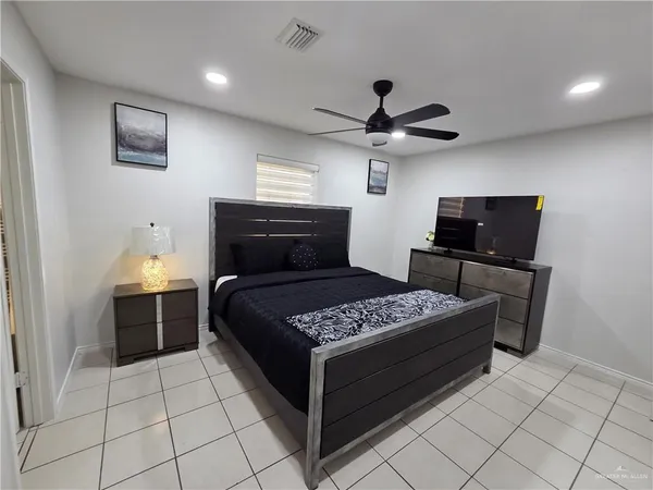 a bedroom with a bed and a television