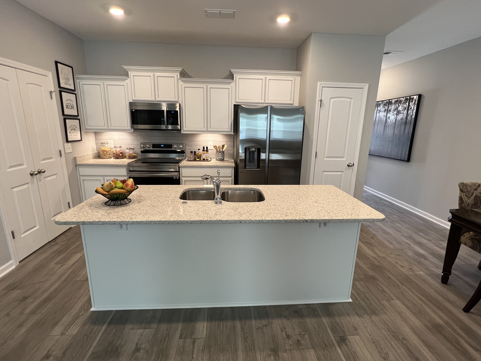 5741 Dockside Drive Rockvale, TN 37153 - Photo 7 of 22 a kitchen with stainless steel appliances a refrigerator a stove a sink dishwasher and white cabinets with wooden floor
