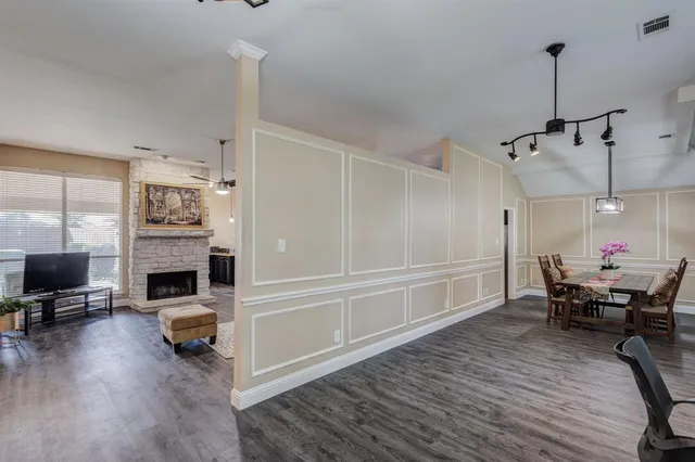 a dining room with furniture and wooden floor