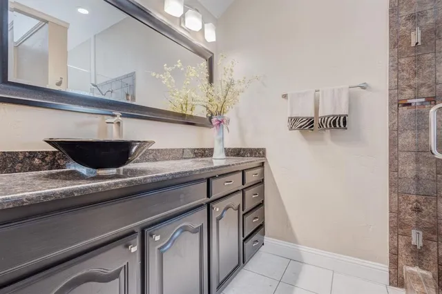 a bathroom with a shower and a sink