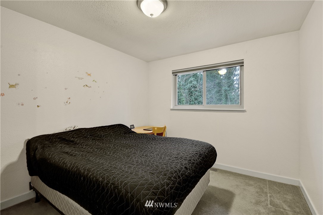 1104 204th Place Southeast Bothell, WA 98012 - Photo 12 of 22 a bedroom with a bed window and wall painting