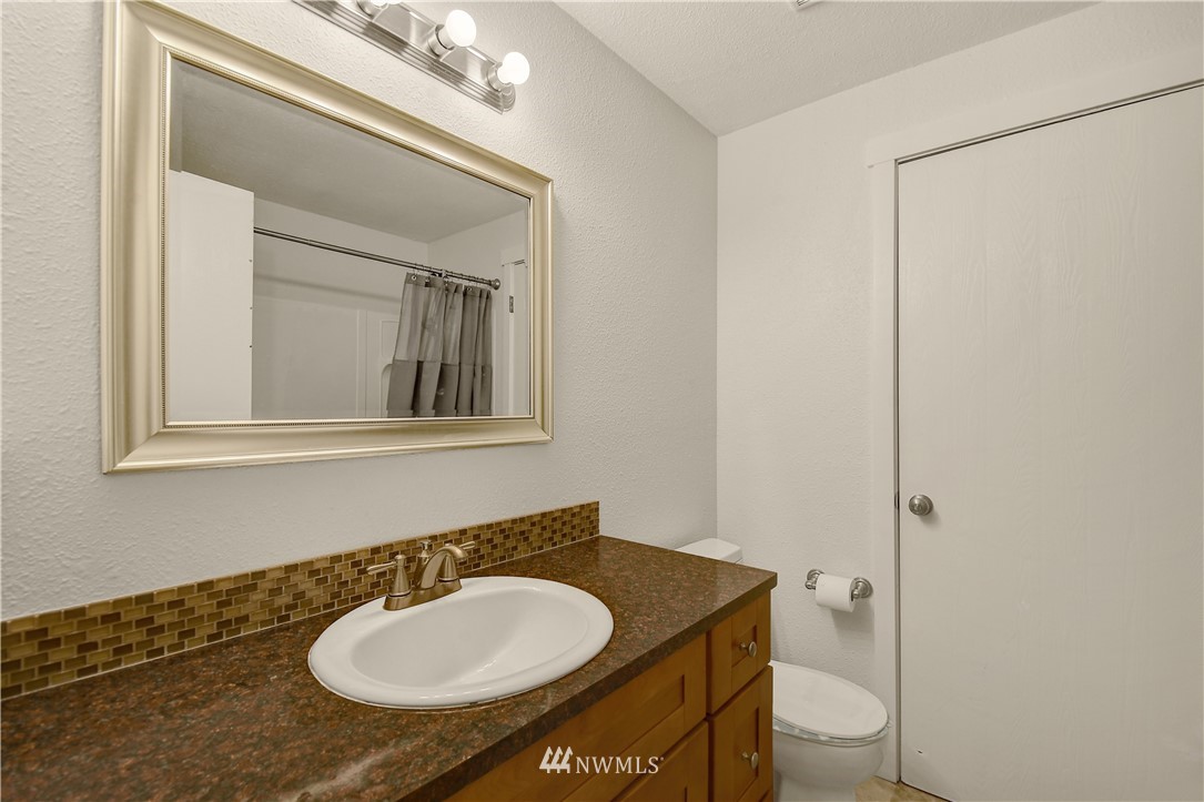1104 204th Place Southeast Bothell, WA 98012 - Photo 13 of 22 a bathroom with a toilet sink and mirror