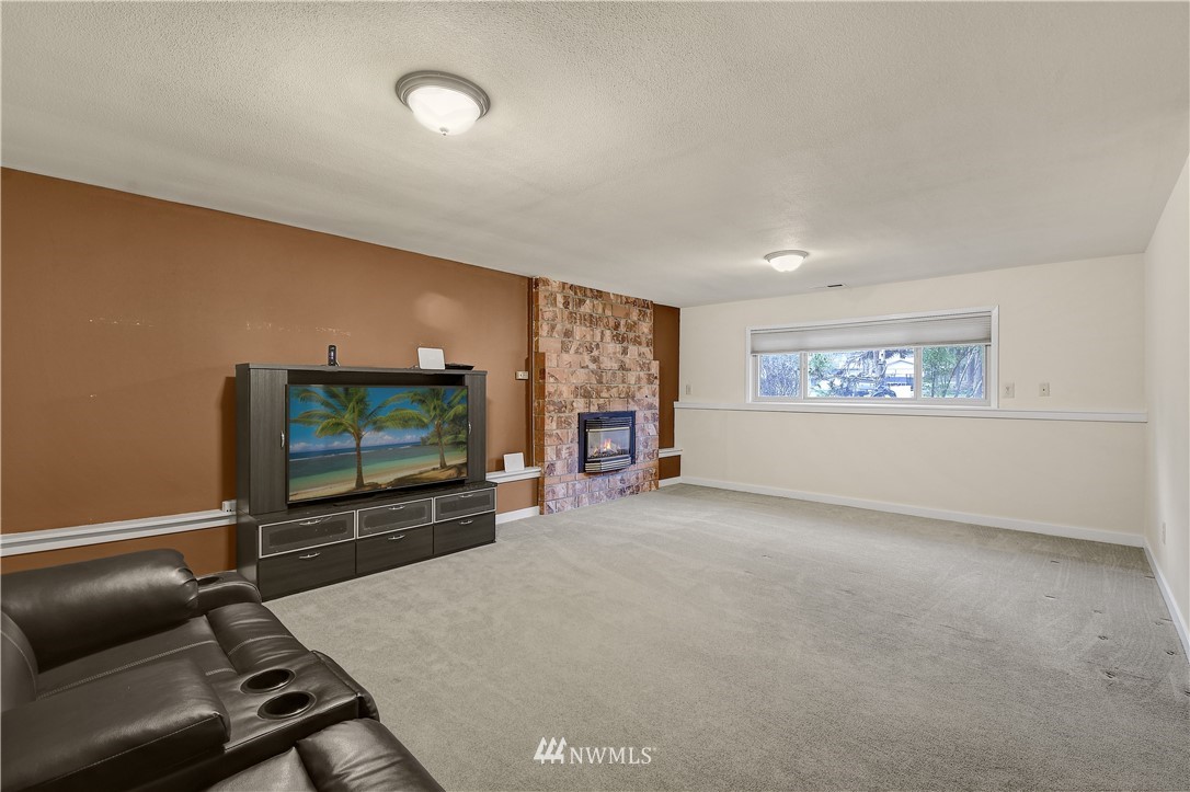 1104 204th Place Southeast Bothell, WA 98012 - Photo 15 of 22 a living room with furniture and a flat screen tv