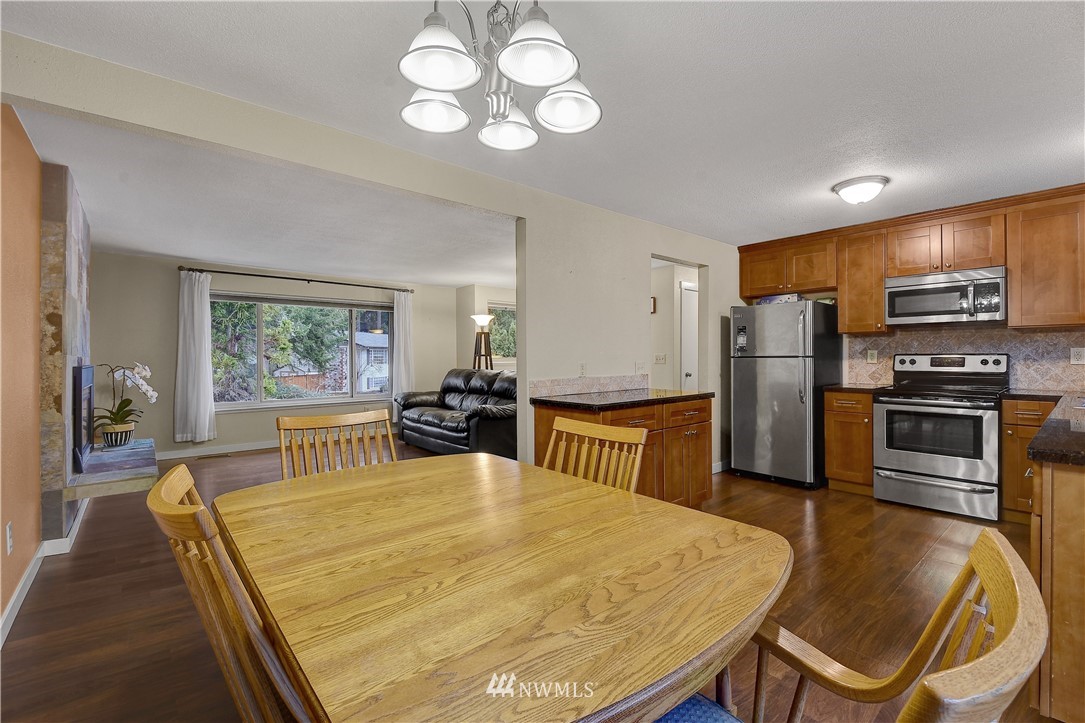 1104 204th Place Southeast Bothell, WA 98012 - Photo 5 of 22 a large kitchen with a table and chairs