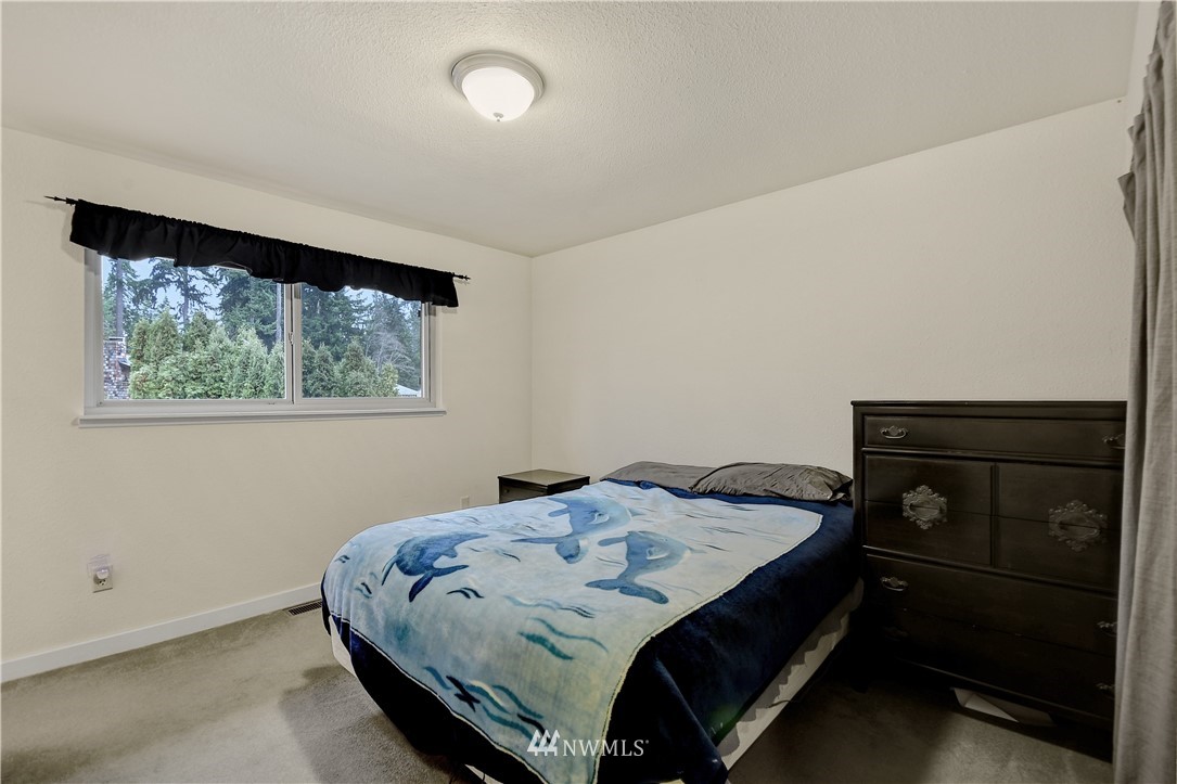1104 204th Place Southeast Bothell, WA 98012 - Photo 9 of 22 a bedroom with a bed and a window