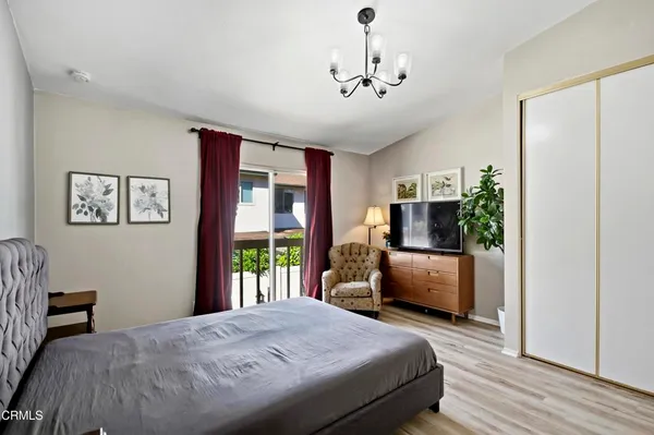 a bedroom with furniture and a flat screen tv
