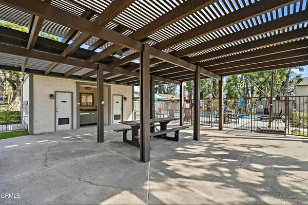 an aerial view of a house with outdoor seating