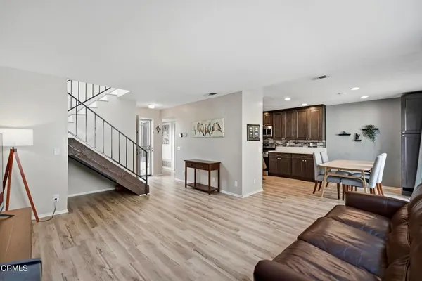 a kitchen with kitchen island a refrigerator stove microwave and cabinets