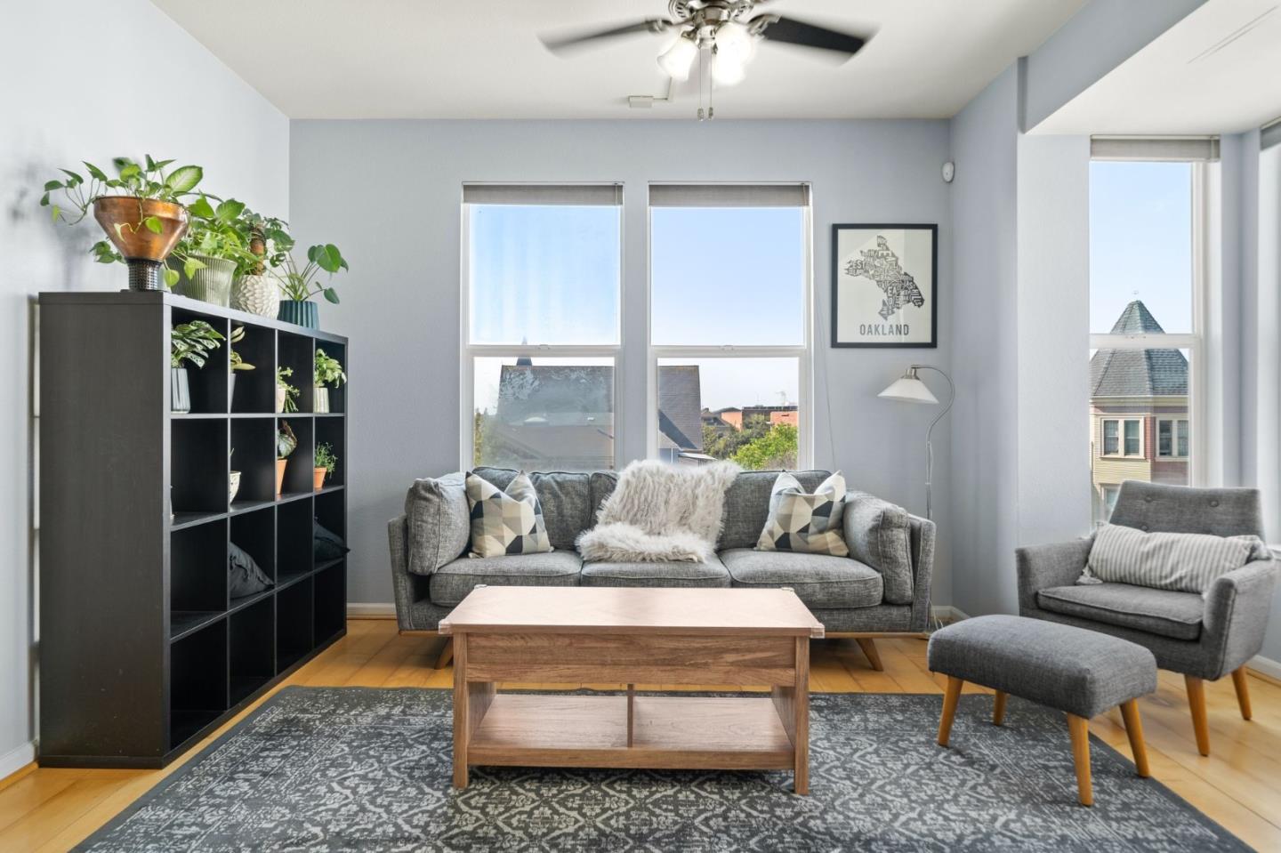 655 12th Street, Unit 312 Oakland, CA 94607 - Photo 2 of 14 a living room with furniture a chandelier and a rug