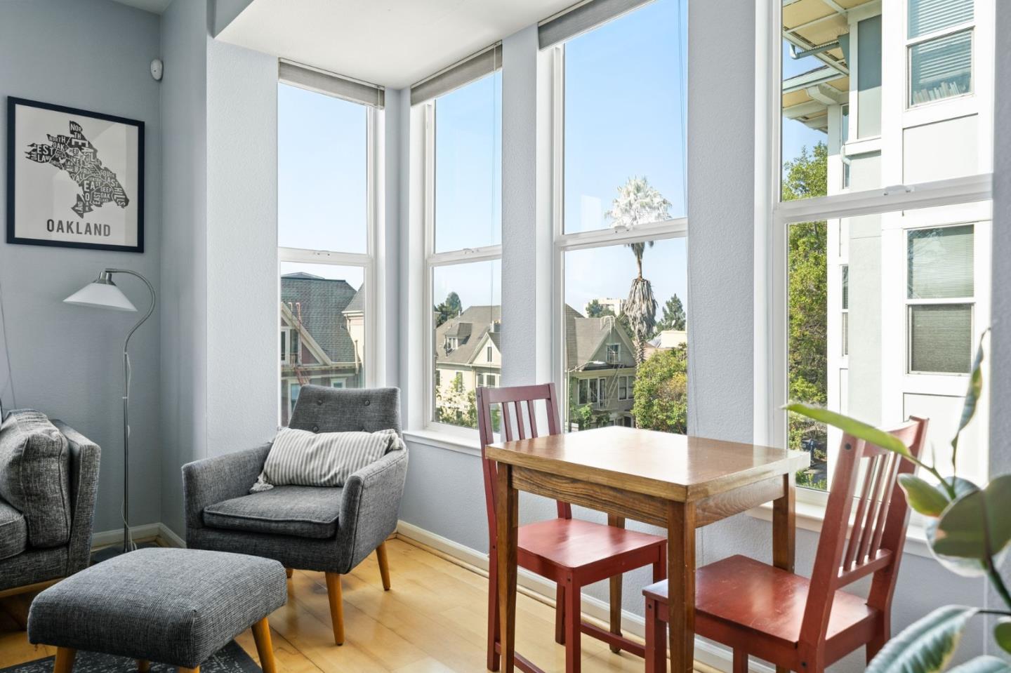 655 12th Street, Unit 312 Oakland, CA 94607 - Photo 3 of 14 a view of a dining room with furniture large windows and wooden floor