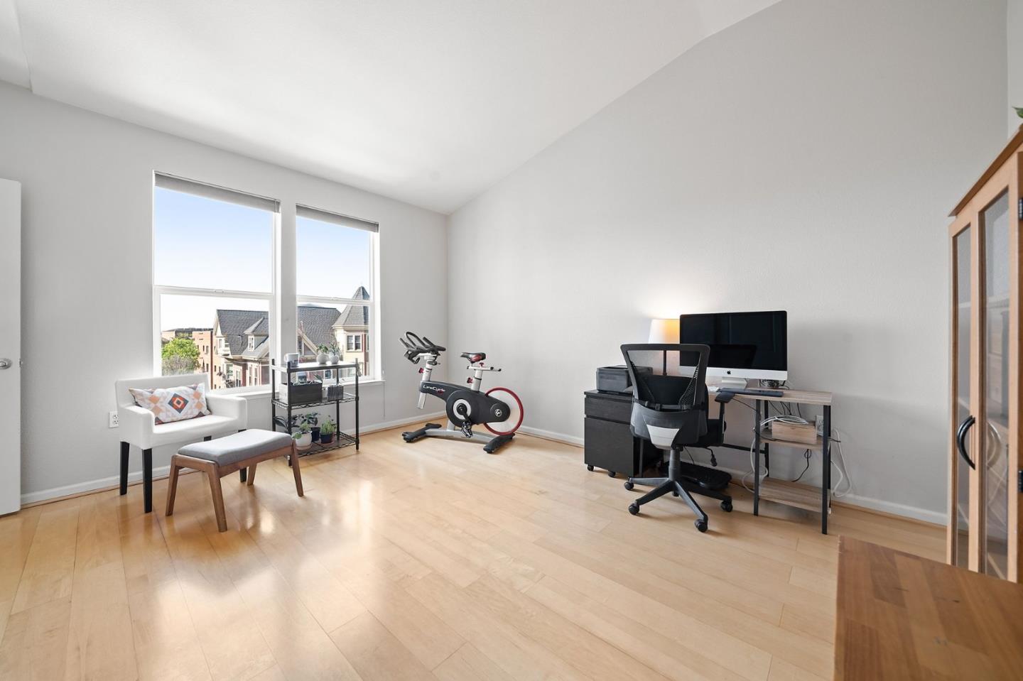 655 12th Street, Unit 312 Oakland, CA 94607 - Photo 8 of 14 a living room with furniture floor to ceiling window and a flat screen tv