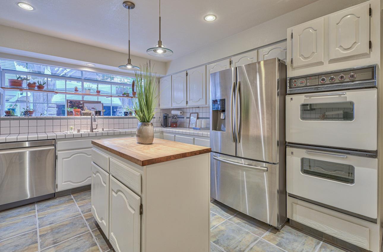 22511 Murietta Road Salinas, CA 93908 - Photo 26 of 58 a kitchen with stainless steel appliances granite countertop a refrigerator a stove a sink and white cabinets