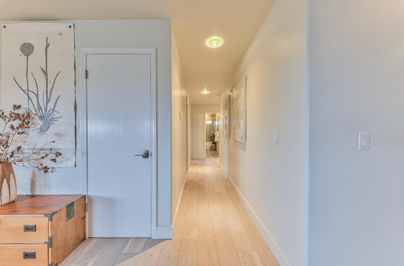 22511 Murietta Road Salinas, CA 93908 - Photo 37 of 58 a view of a hallway with wooden floor and a bathroom