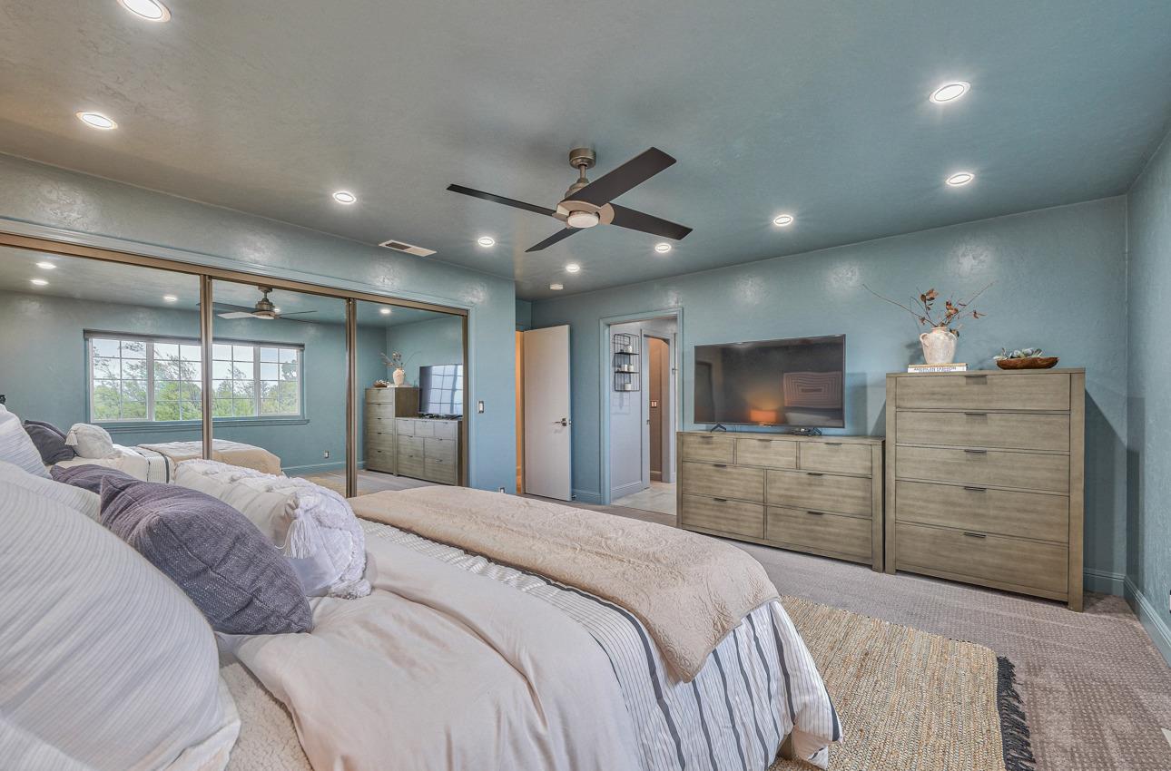22511 Murietta Road Salinas, CA 93908 - Photo 40 of 58 a bedroom with a large bed and a ceiling fan