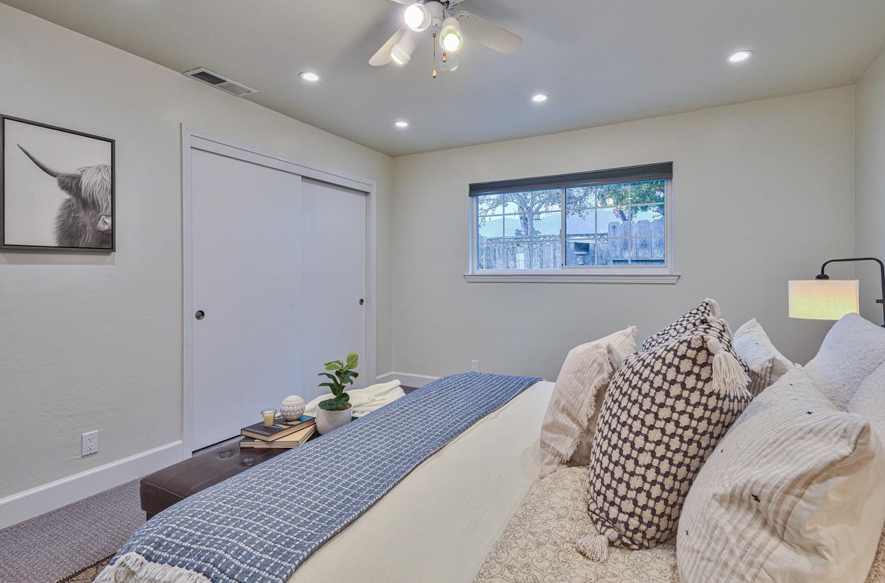 22511 Murietta Road Salinas, CA 93908 - Photo 48 of 58 a bedroom with a bed and a chandelier