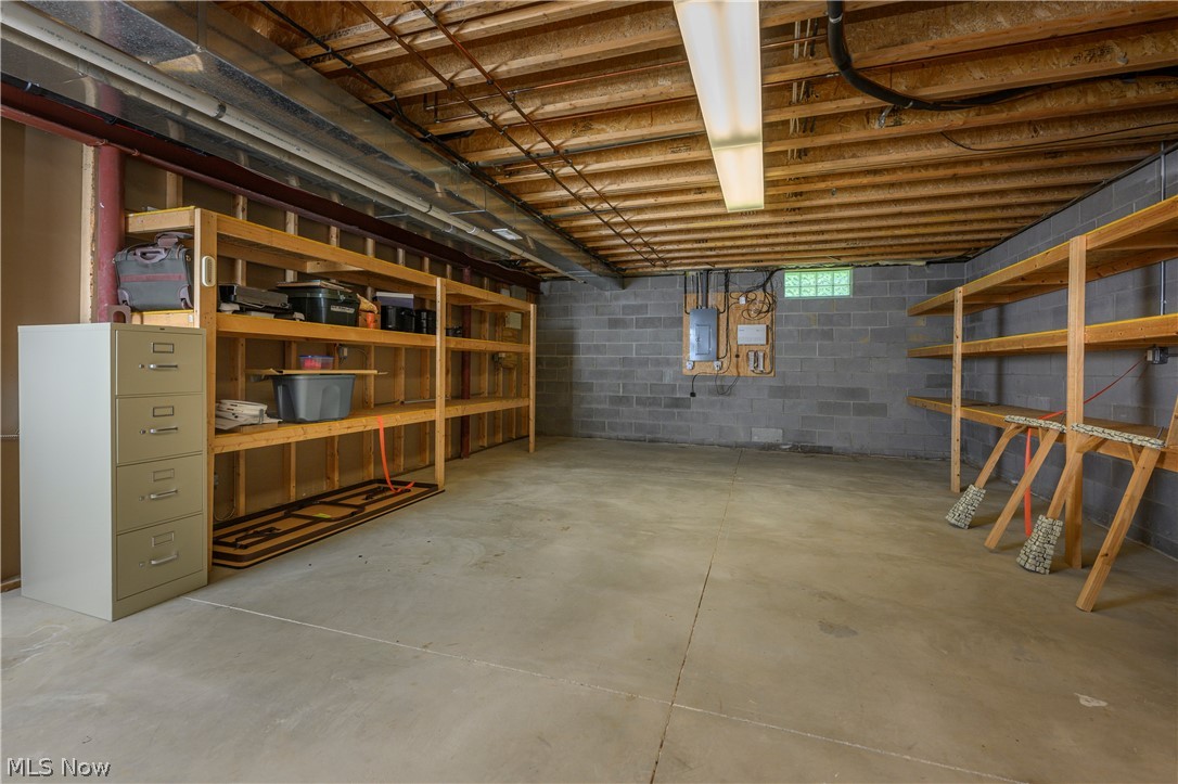 8745 Broadview Road Broadview Heights, OH 44147 - Photo 29 of 49 Unfinished basement featuring concrete flooring, exposed wood joists, and block walls
