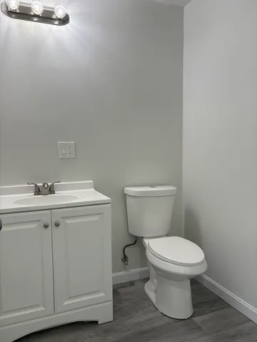 a white toilet sitting next to a bathroom sink