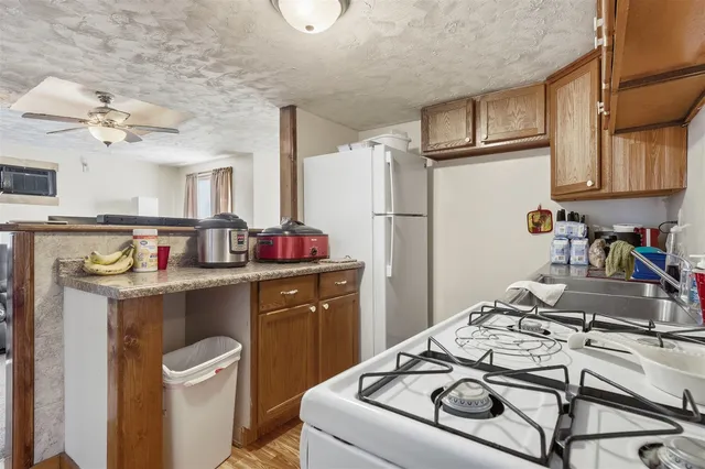 a kitchen with a sink appliances and cabinets
