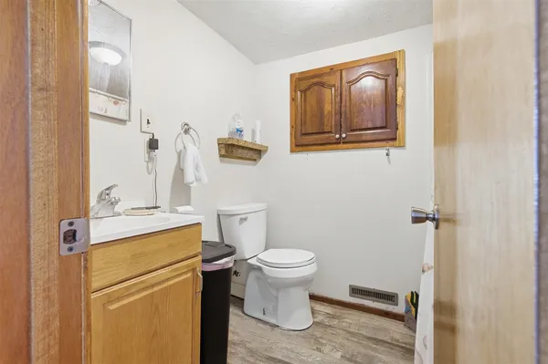 a bathroom with a toilet sink and mirror