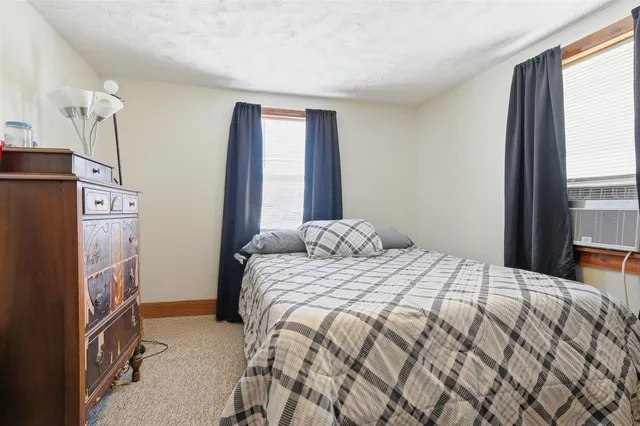 a bedroom with a bed closet and a window