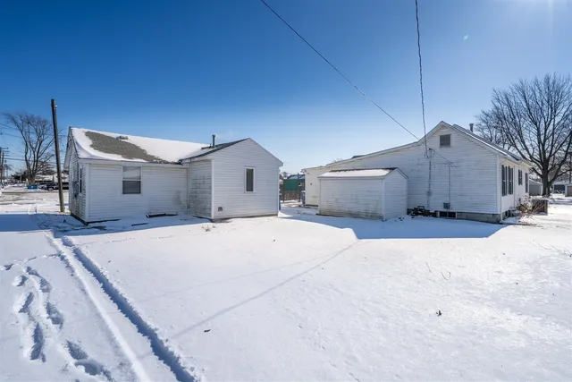 a view of a house with a snow in the yard