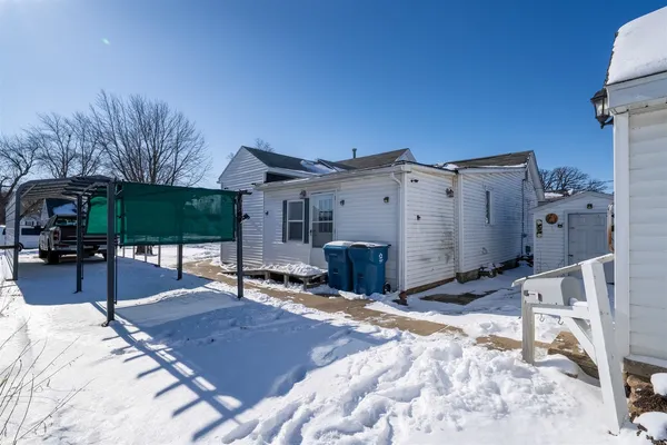 a view of a house with backyard porch and sitting area
