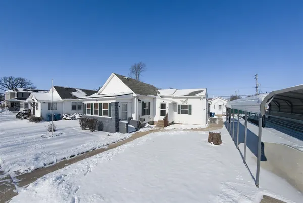 a view of a house with wooden fence
