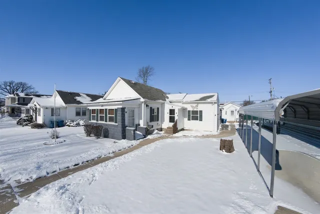 a view of a house with wooden fence