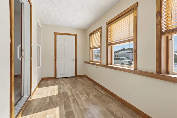 a view of an empty room with windows