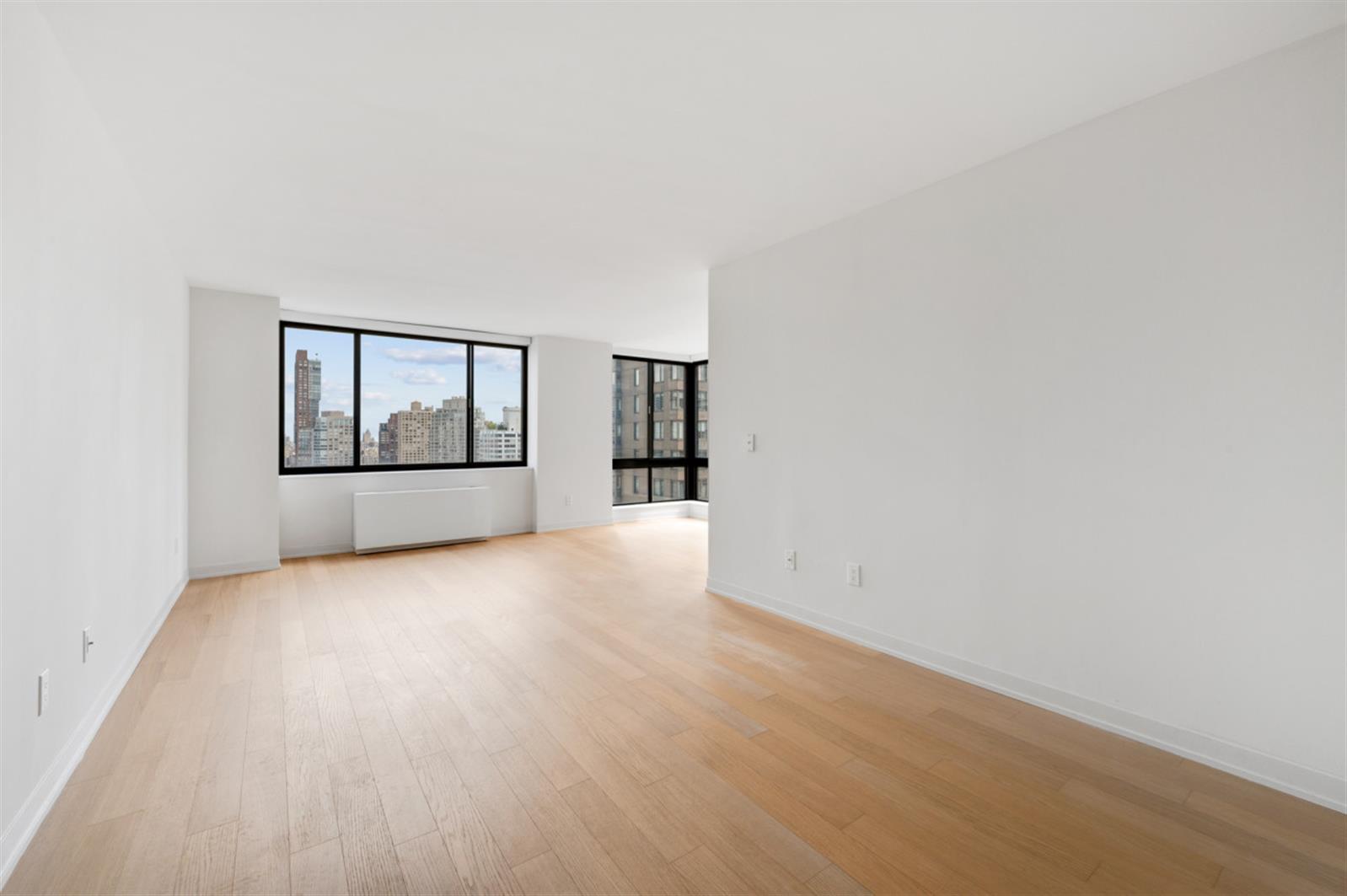 1 Columbus Place, Unit N31B Manhattan, NY 10019 - Photo 2 of 8 an empty room with windows and cabinet