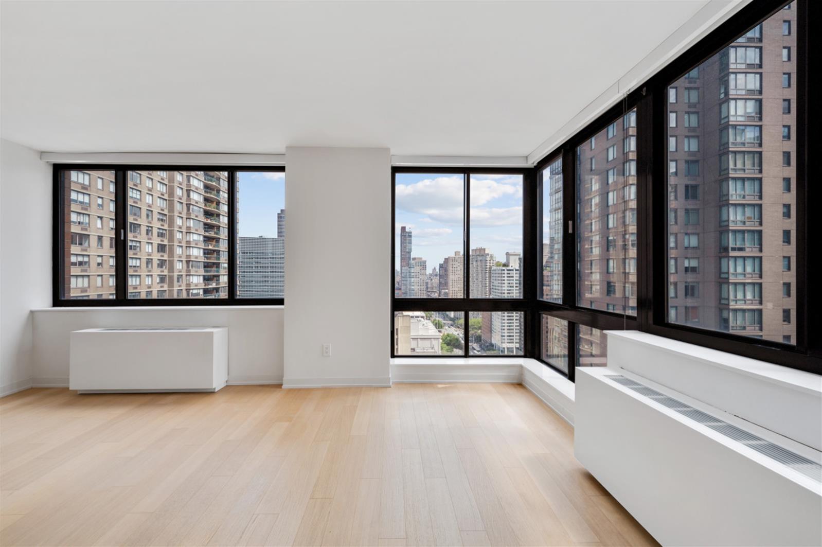 1 Columbus Place, Unit N31B Manhattan, NY 10019 - Photo 4 of 8 a view of an empty room with a window