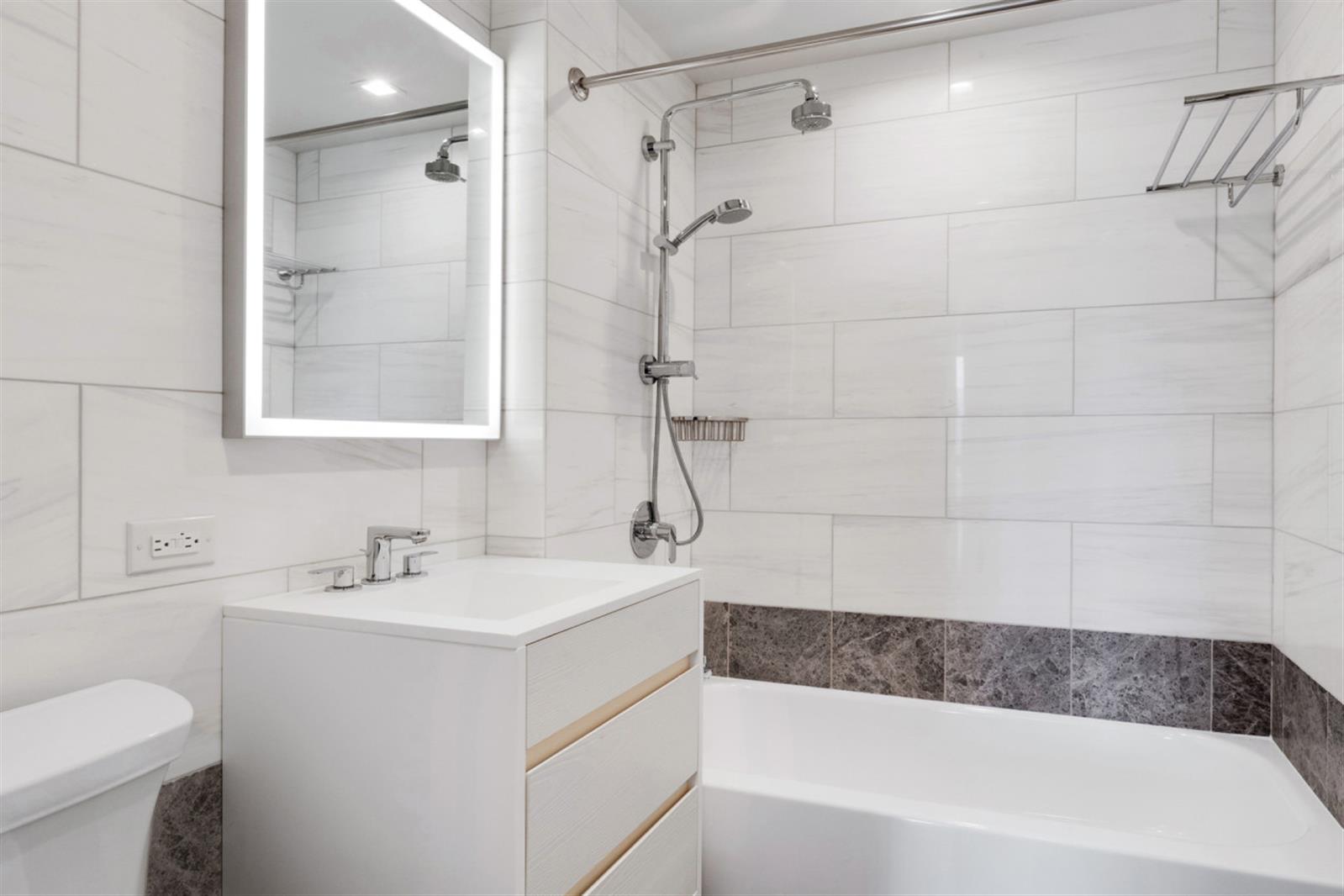 1 Columbus Place, Unit N31B Manhattan, NY 10019 - Photo 7 of 8 a bathroom with a bathtub and a sink