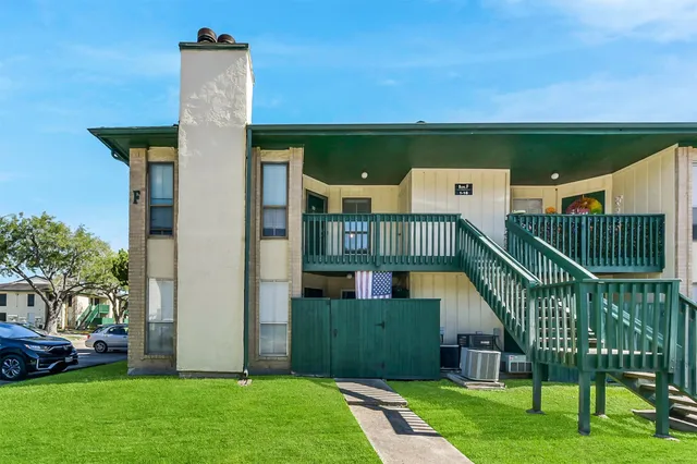a view of a chair and table in the garden