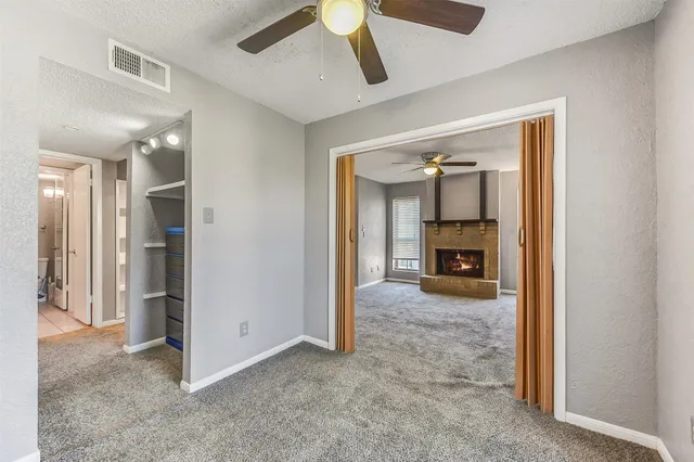 a bathroom with a granite countertop sink toilet a mirror and shower