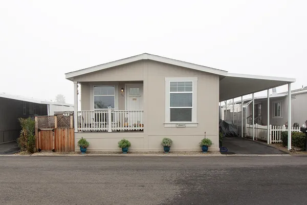 a front view of a house with a garden