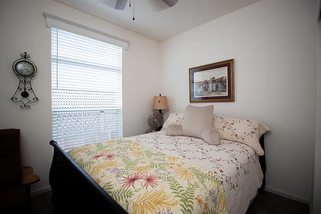 a large bed sitting in a bedroom next to a window