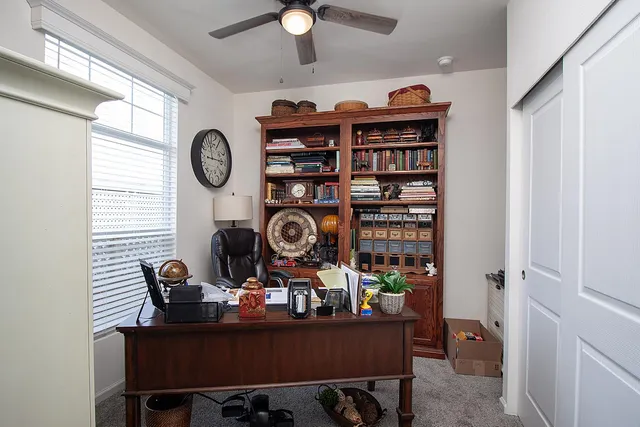 a work room with furniture and book shelf