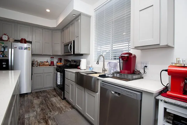 a kitchen with a sink a stove and refrigerator
