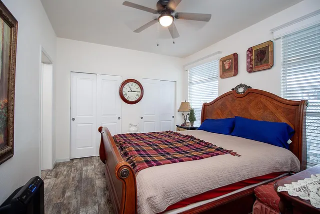 a bedroom with a bed and a chandelier