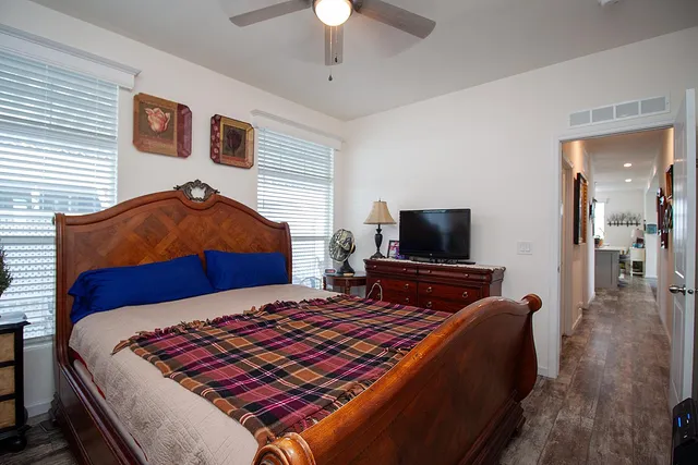 a bedroom with a bed and a television