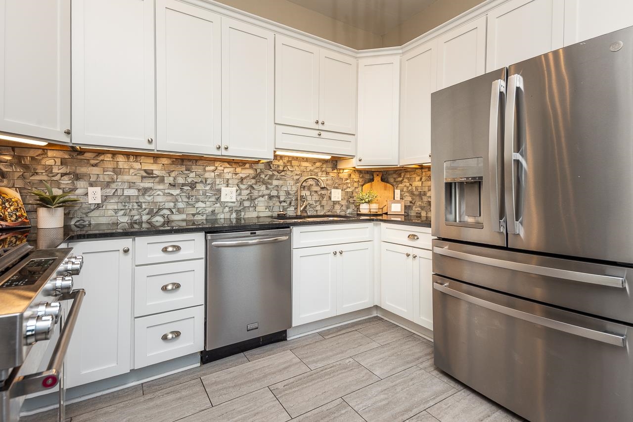 519 Summitt Street Memphis, TN 38104 - Photo 14 of 40 a kitchen with cabinets stainless steel appliances and a counter space